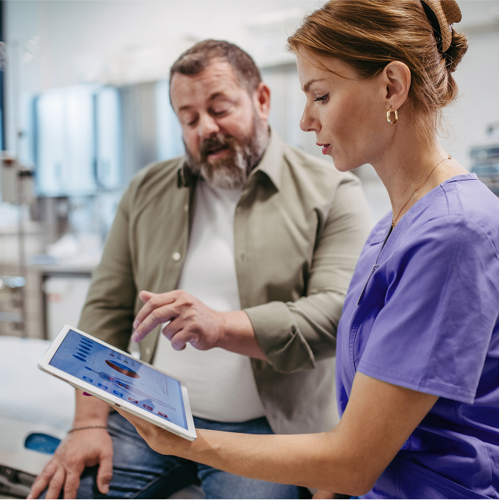 Scientist showing medical progress on a tablet to a man