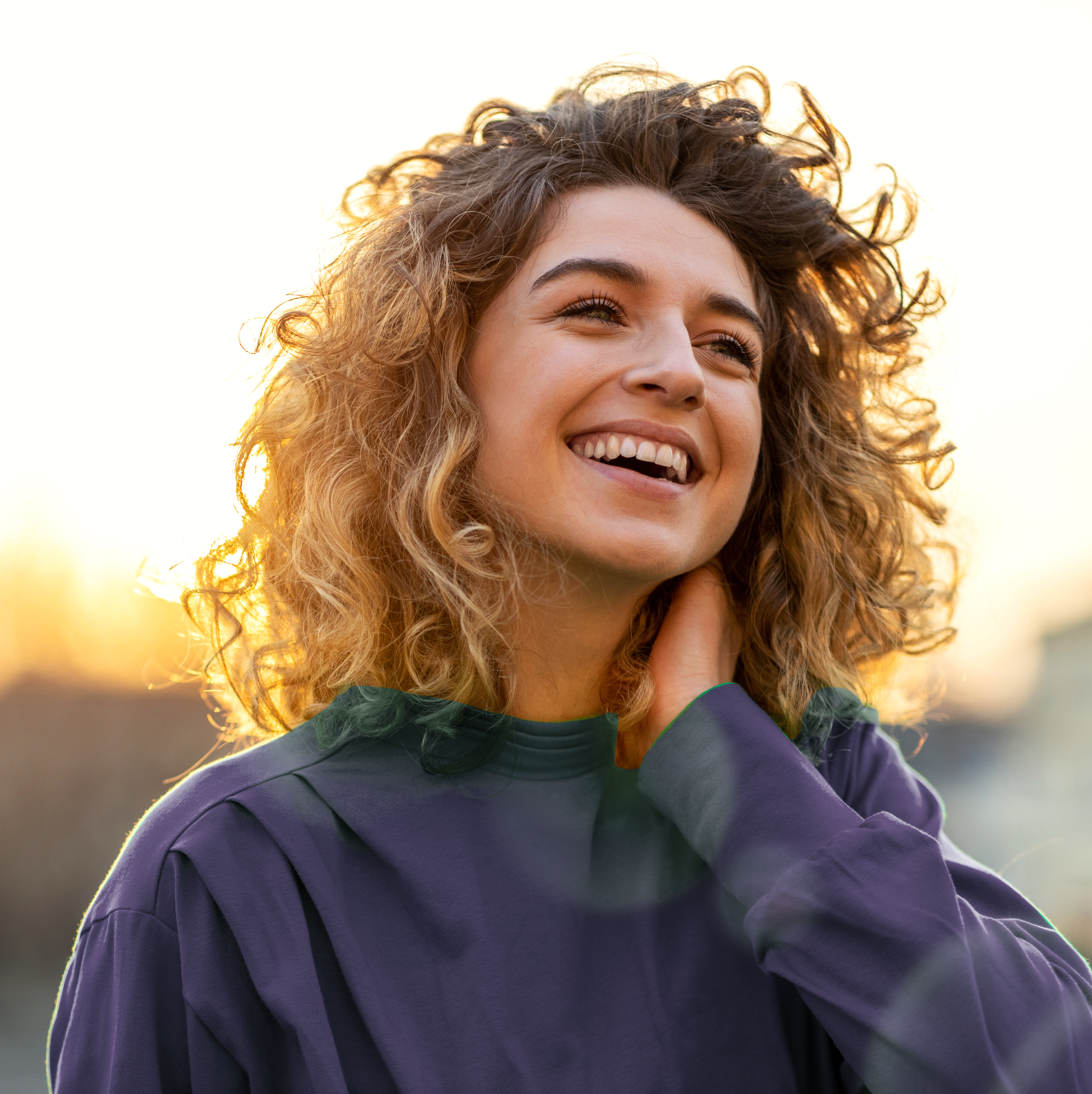 Happy woman at sunrise